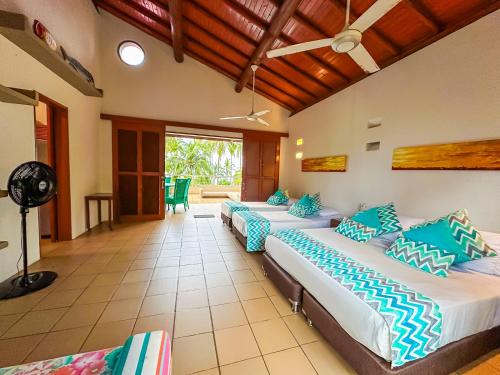 a bedroom with three beds in a room at Hotel Chiniu in Palomino