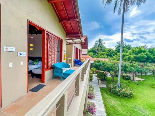 a balcony of a resort with a bed and a bedroom at Hotel Chiniu in Palomino