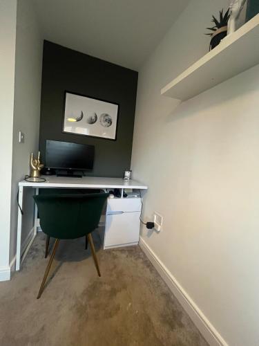 a room with a desk with a computer on it at Mason Gardens Home in Chilton
