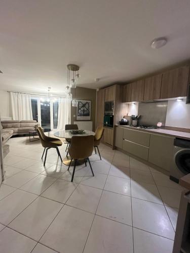a kitchen and living room with a table and chairs at Mason Gardens Home in Chilton