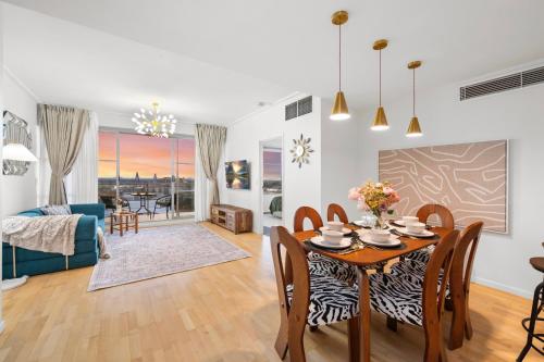 a dining room and living room with a table and chairs at Urban Oasis Escape - Views丨Comfort丨Elegance in Sydney