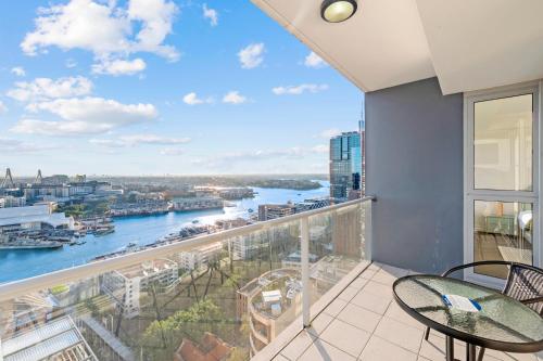 a balcony with a view of the river at Urban Oasis Escape - Views丨Comfort丨Elegance in Sydney
