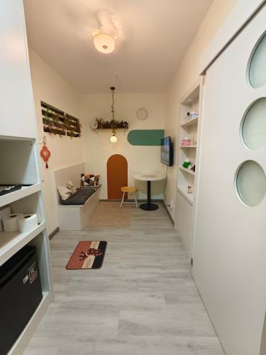 a room with a hallway with a table and a desk at Unisuites Kampar COZY 1 BR 4pax in Kampar