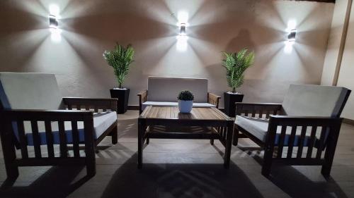 a room with two chairs and a wooden table with a table sidx sidx at Apartments & Dream Rooms in Niš