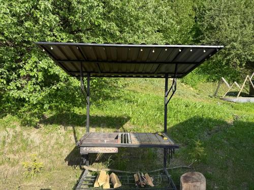 a picnic table with a roof on top of it at Holiday Home Near FOREST in Skhidnitsa