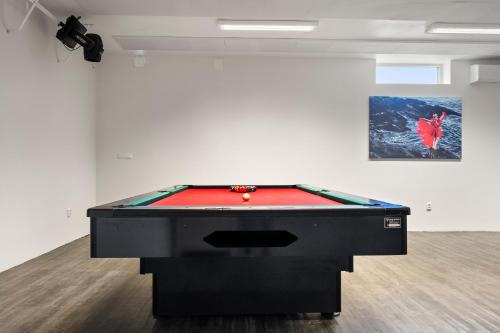 a pool table in a room with a painting at Kinn Hotell Florø in Florø