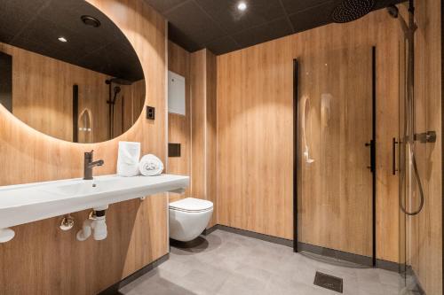 a bathroom with a toilet and a sink and a shower at Kinn Hotell Florø in Florø