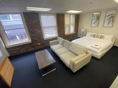 a living room with a bed and a couch at Michie House in College Hill in Providence