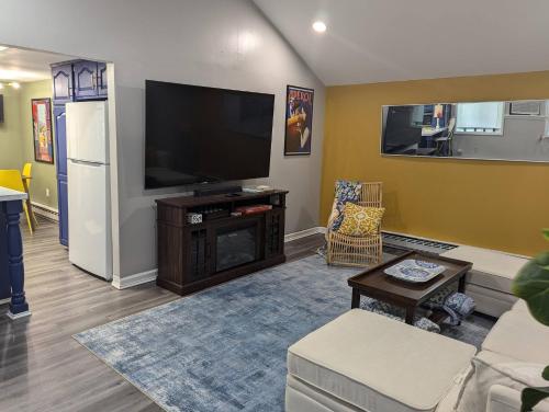 a living room with a large flat screen tv at Secluded Getaway Near Downtown, Airport, Hospitals in Pittston