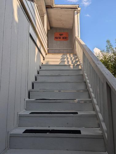 a staircase leading up to a house with a sign on it at Secluded Getaway Near Downtown, Airport, Hospitals in Pittston