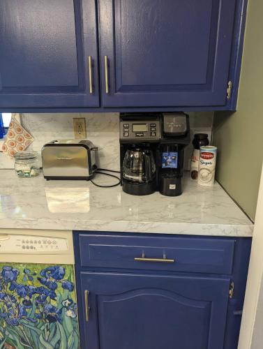 a kitchen counter with blue cabinets and a toaster at Secluded Getaway Near Downtown, Airport, Hospitals in Pittston