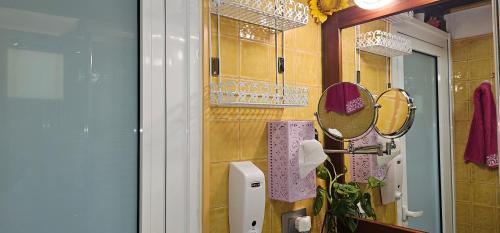 a bathroom with a mirror and a sink at Casa Rural Eneida in Chiquenge