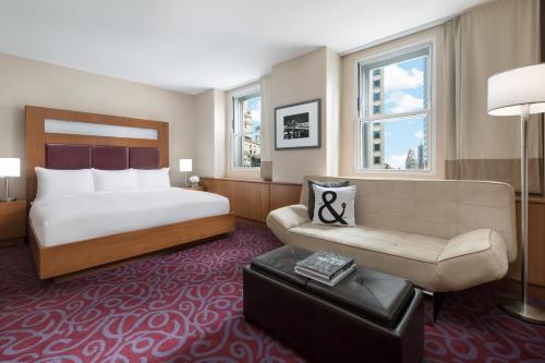 a hotel room with a bed and a couch at Hotel 57 in New York