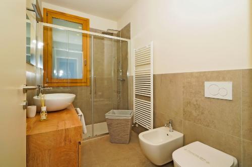 a bathroom with a sink and a toilet and a shower at La Fontanina in Vobarno