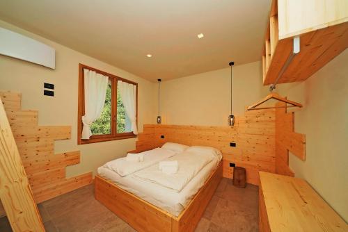 a bedroom with a bed in a wooden room at La Fontanina in Vobarno