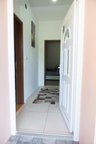 an open door into a room with a bedroom at Kuća NP in Bačka Topola