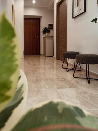 a hallway with two chairs and a table and a door at Paola HOME in Varazze