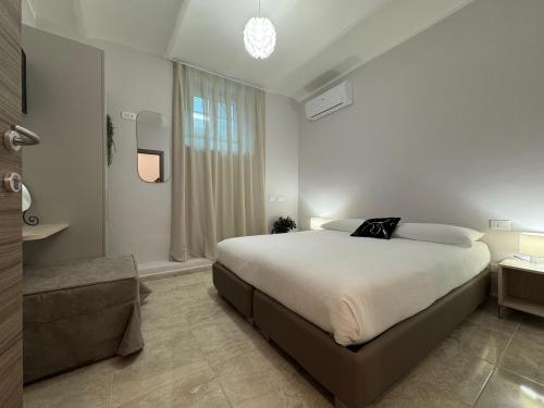 a bedroom with a large bed and a window at Paola HOME in Varazze