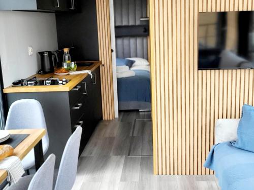 a small room with a kitchen and a bedroom at Houseboat SeeSea Mazury - Domek na wodzie Bogaczewo k Giżycka in Bogaczewo