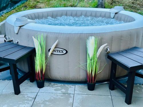 a hot tub with two benches in front of it at Iepurasul Sinaia in Sinaia