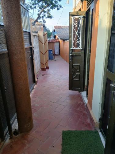 an alleyway leading to a building with a door at muffler motel bukesa in Kampala