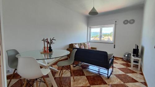 a room with a table and chairs and a window at Li-miana Alojamento Local in Ponte de Lima