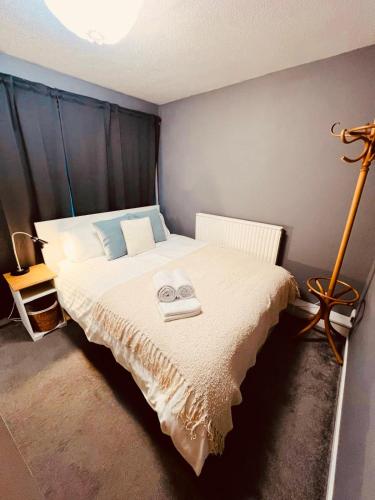a bedroom with a bed with two towels on it at Bank West in Edinburgh