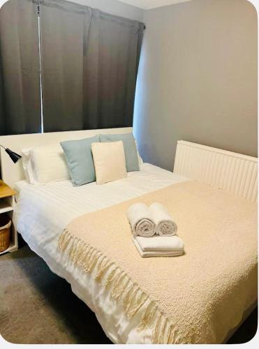 a bedroom with a bed with towels on it at Bank West in Edinburgh