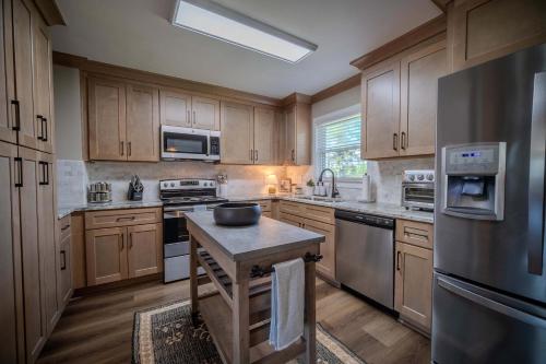 a kitchen with wooden cabinets and stainless steel appliances at Parkside Place Entire Home in Acworth in Acworth