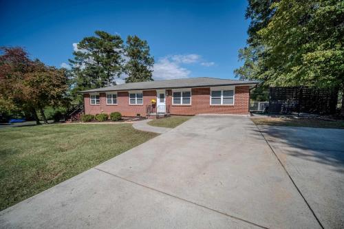a red brick house with a driveway at Parkside Place Entire Home in Acworth in Acworth