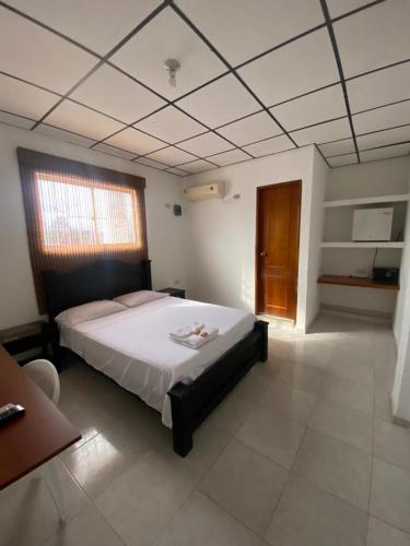 a bedroom with a large bed in a room at Hotel Walt Sevas La Jagua in La Jagua de Ibirico