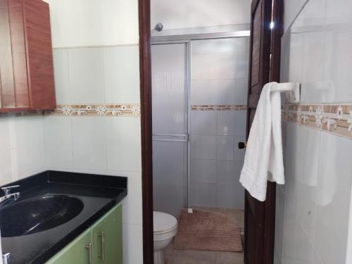 a bathroom with a toilet and a sink and a shower at Casa, Anapoima Cundinamarca in Anapoima