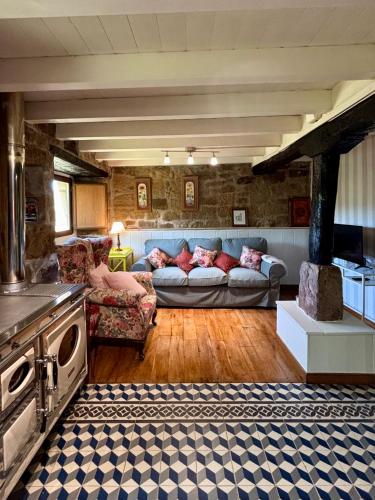a living room with a couch and a table at Cabaña Pasiega Lo Macario in Resconorio