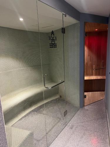 a glass shower in a bathroom with a red door at Tizate Residents 202 in Cruz de Huanacaxtle