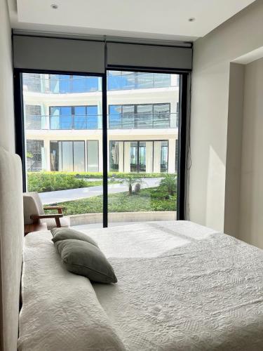 a bedroom with a bed and a large window at Tizate Residents 202 in Cruz de Huanacaxtle