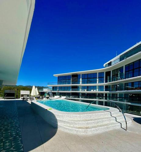 a swimming pool in front of a building at Tizate Residents 202 in Cruz de Huanacaxtle