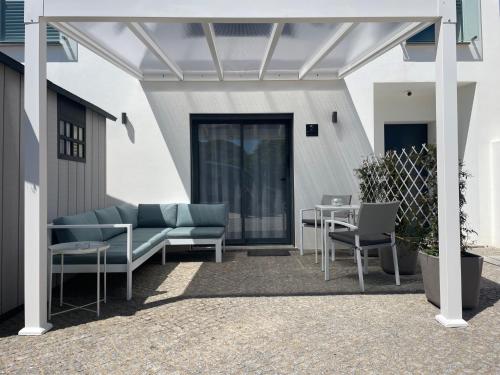 a pergola with chairs and tables on a patio at SalemaView Ensuite bedroom in Salema