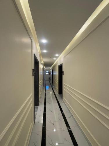 a hallway with white walls and a long corridor at Old Town Hotel in Aqaba