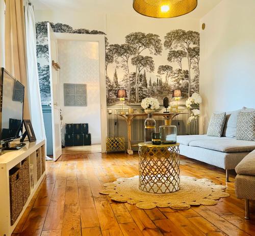 a living room with a couch and a table at Fabuleux! La Maison Au Bois Dormant in Barraux
