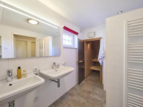 a white bathroom with a sink and a mirror at Farmhouse in Limburg near Designer Outlet in Roggel
