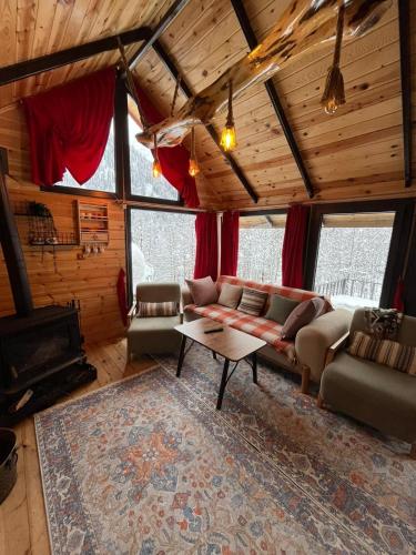 a living room with a couch and a table at Ayder Villas in Çamlıhemşin