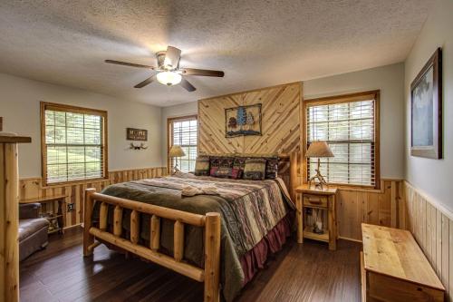 a bedroom with a bed and a ceiling fan at Bear Retreat in Sevierville