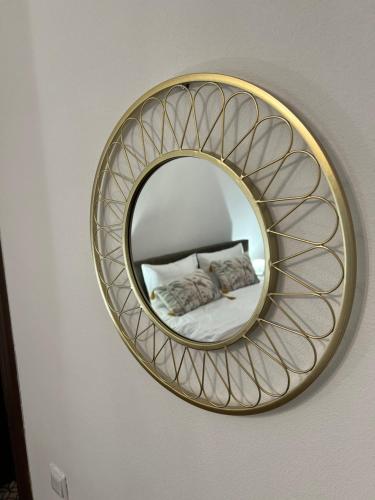 a mirror on a wall with a bed in it at S-HOUSE Avrig Apartament Spațios cu Terasă Privată lângă Sibiu in Avrig
