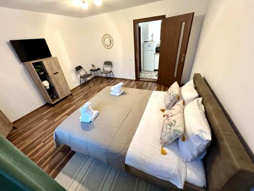 a bedroom with a large bed in a room at S-HOUSE Avrig Apartament Spațios cu Terasă Privată lângă Sibiu in Avrig