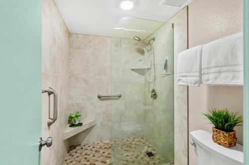 a bathroom with a shower with a glass door at Maui Kaanapali Villas A414 in Lahaina