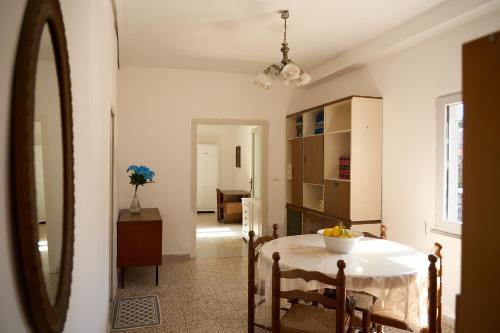 a kitchen with a table with a bowl of fruit on it at Casa Olimpia in Forio d'Ischia