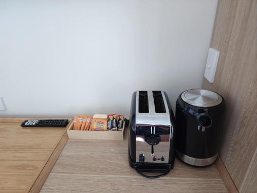 a toaster sitting on a counter next to a trash can at Studio room in Cairns Esplanade! Ocean view! Heart of Cairns in Cairns