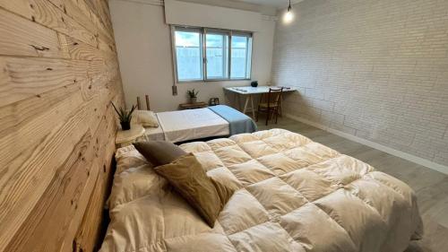 a bedroom with two beds and a table in it at Casa Sanuk in Poio