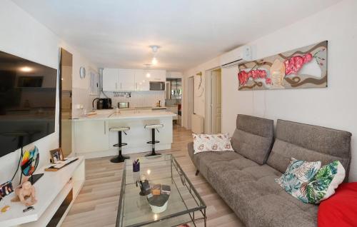 un salon avec un canapé et une table en verre dans l'établissement 1 Bedroom Amazing Apartment In Lunel, à Lunel