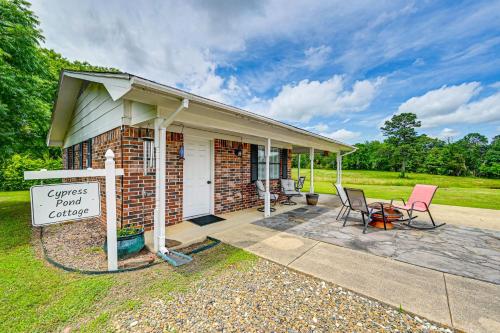 a house with a sign that reads congress yard cottage at Fishing Pond and Pier Secluded Broken Bow Cottage! in Broken Bow